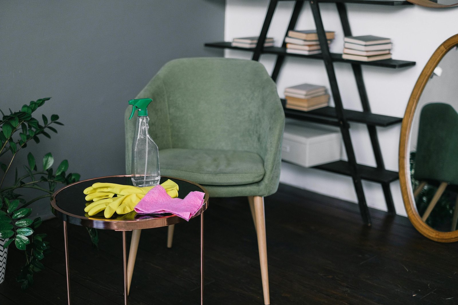 Clean and organized living room with modern decor featuring cleaning supplies on a table.